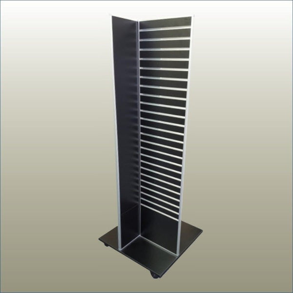 A black, free-standing four-sided display unit with slatwall panels on all sides, equipped with castor wheels for mobility.