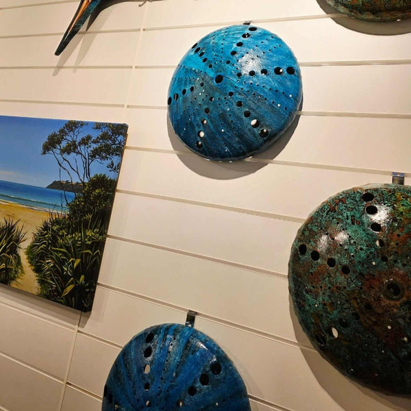 Decorative ceramic pieces displayed on 150mm white slatwall attached with Plankwall Picture Hooks.