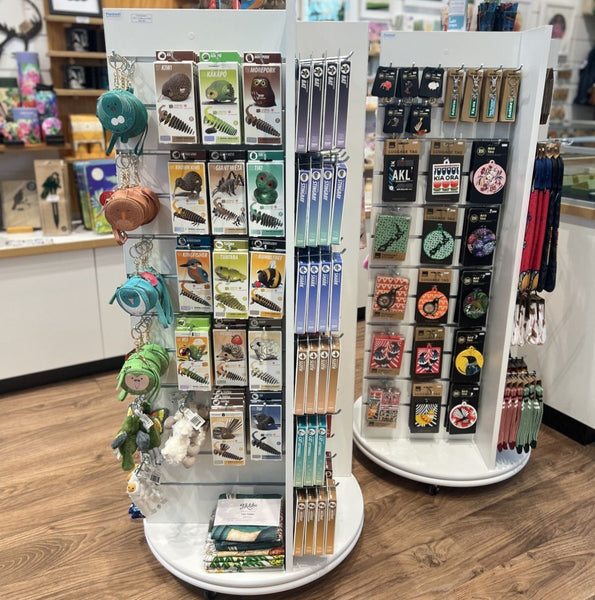 2x Plankwall freestanding four-sided display unit with slatwall panels on all sides displaying retail items in a store