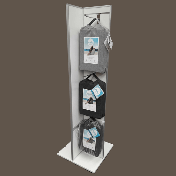 A tall , narrow Plankwall freestanding four-sided display unit with slatwall panels on all sides displaying bean bags on hooks on a cutout background