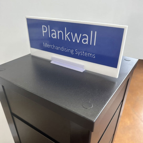 detail of countertop retail display stand in black with friction grip holder sign