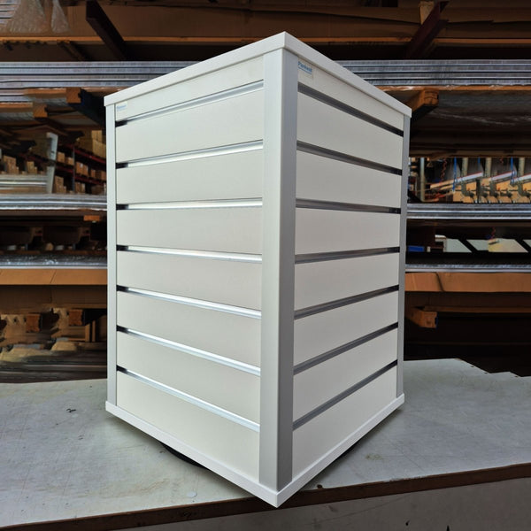 white rotating countertop slatwall retail display stand in a factory setting
