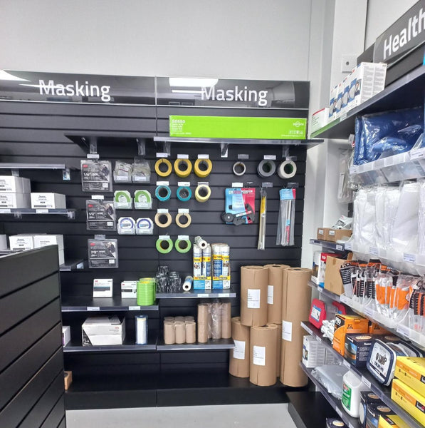 Slatwall retail wall features header signage in store aisle with masking tape and health supplies on shelves