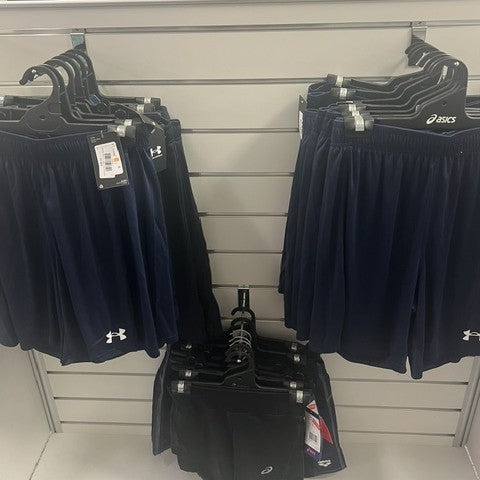 Navy athletic shorts on hangers with brand labels in a store setting  hanging on single backplate prong hooks