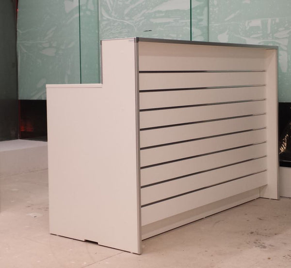 Modern slatwall cashier reception desk with a glass wall in the background