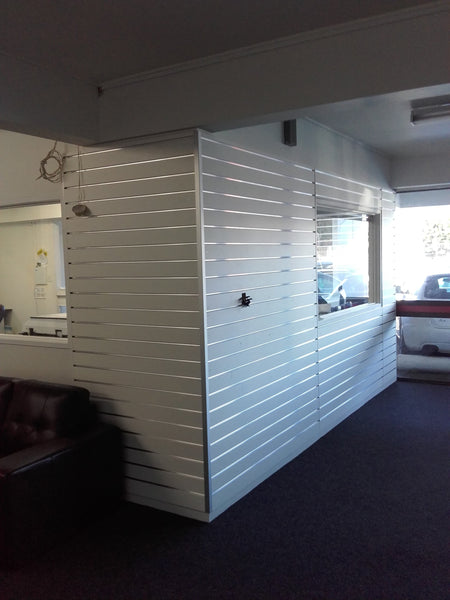 Ra18 aluminium corner joinery profile used to join two slatwall walls in a reception room