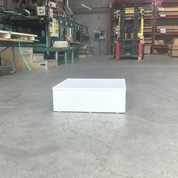 Small white retail display plinth stand with taped edges for showroom and store displays