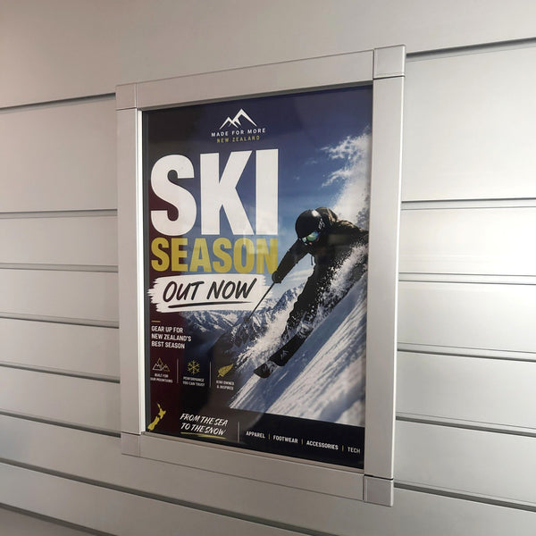 Promotional poster for ski season on a metallic surface