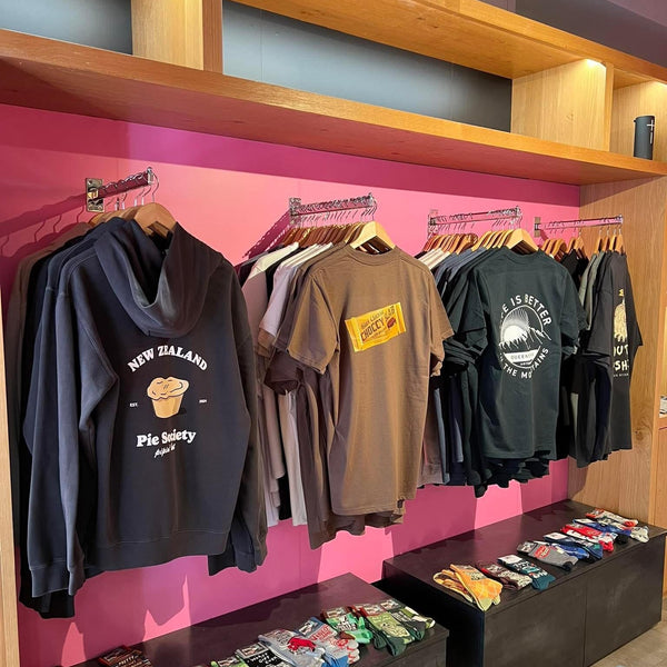 tee shirts and mens hoodies for sale hanging on chrome straight arm brackets