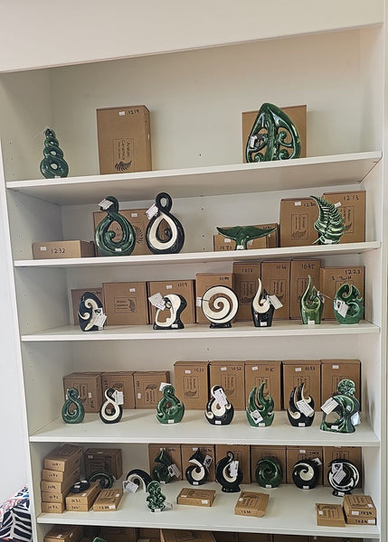 Shelves with decorative figurines and boxes on a white wall background