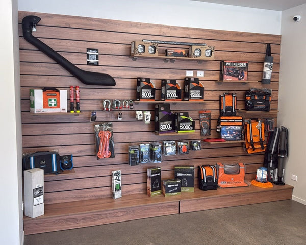 Plankwall wood finish slatwall wall display panel with Plankwall panel shelf base displaying health & Safety items in a showroom setting.