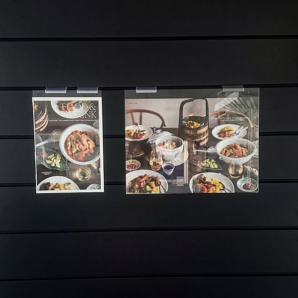 two examples of wall mounted signs on slatwall in sizes a4 and a3 horizontal
