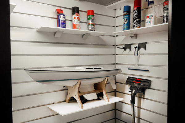 retail view of white melamine shelving with asb aluminium brackets on white slatwall