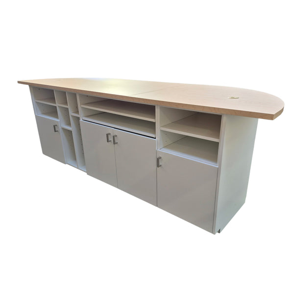 Long wooden desk with storage cabinets on a white background
