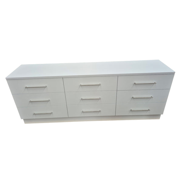 White dresser with multiple drawers on a white background
