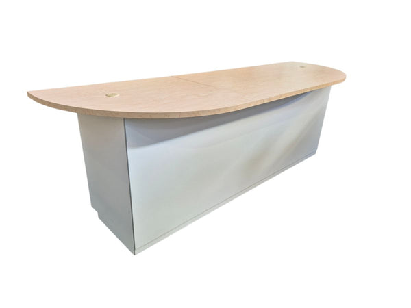 Curved reception desk with wooden top and white base on a white background
