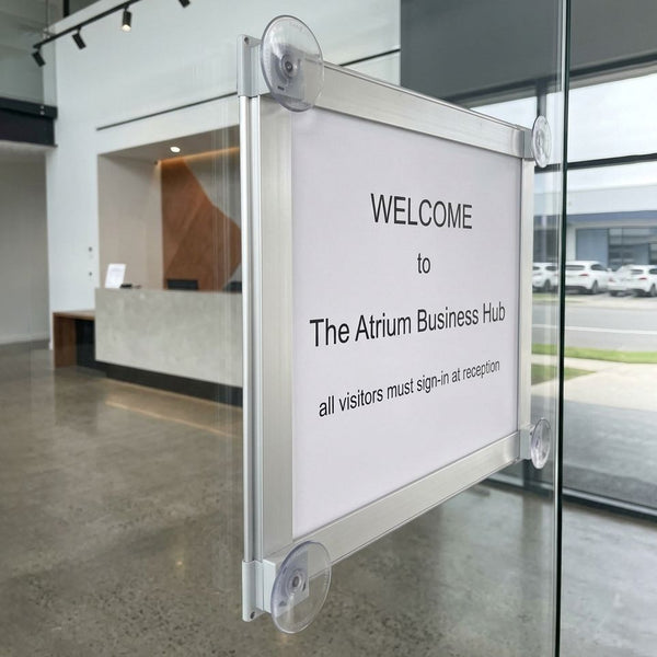 Welcome sign for The Atrium Business Hub with a modern office interior in the background.