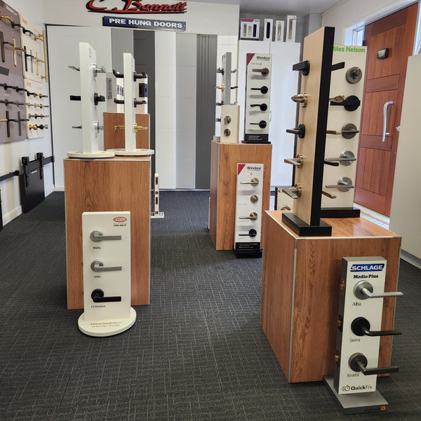 Showroom door handle displays displayed on Plankwall woodgrain floor display stands. 