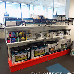 2x Plankwall light free standing display panels in White with red plinth base in retail space with stock