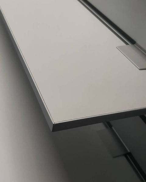 Side view of a white 9mm melamine shelf showing thickness and PVC edge tape on display wall.
