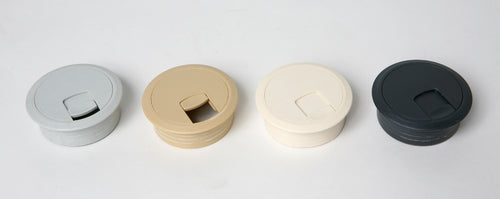 Four Plankwall cable ports in different colours on a white background