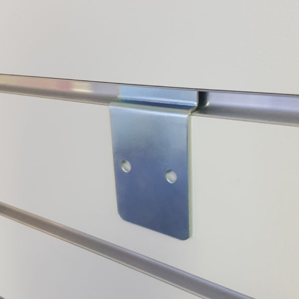 J shaped metal slatwall mounting bracket shown inserted into slatwall groove