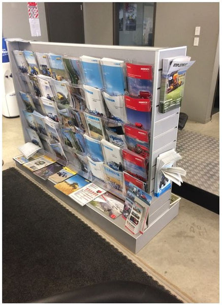 Plankwall slatwall display gondola stand lined with Calext brochure display system pockets used to display collateral
