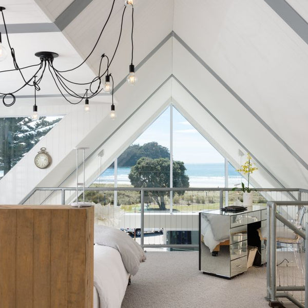 Plankwall 100mm V Groove MDF panels in a white modern architectural beach house overlooking a beautiful New Zealand beach