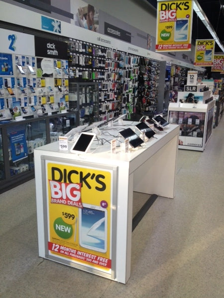 Plankwall electronics display table in white displaying tablets in a Dick Smith electronics retail store