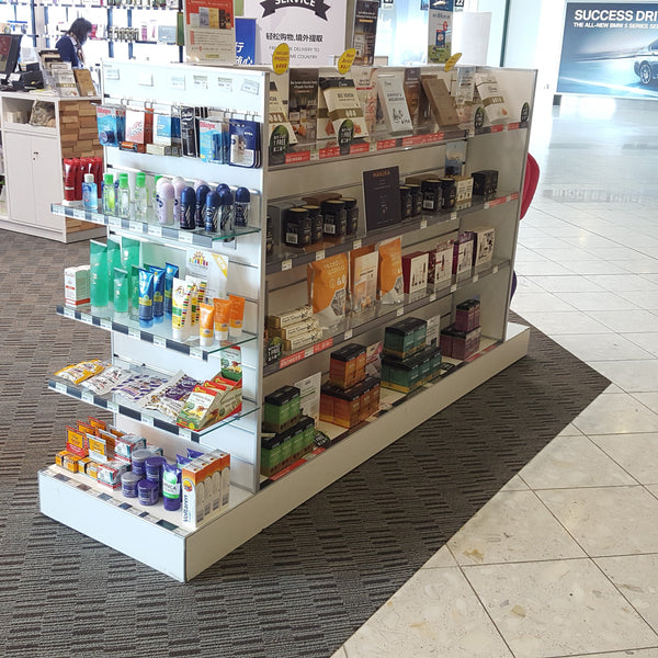 Plankwall G60 Gondola  white with glass shelves stocked in a souvenir shop