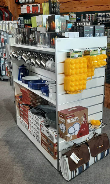 White Plankwall Gondola Display Unit with End panels in retail store with merchandise