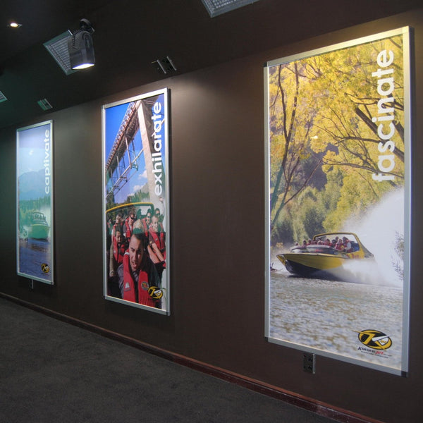 Plankwall large postaframes showing tourism photos against a black wall backdrop