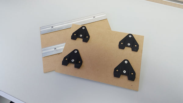 Photo of 2x Plankwall Split Rail and 4x Split Rail Clips mounted on boards