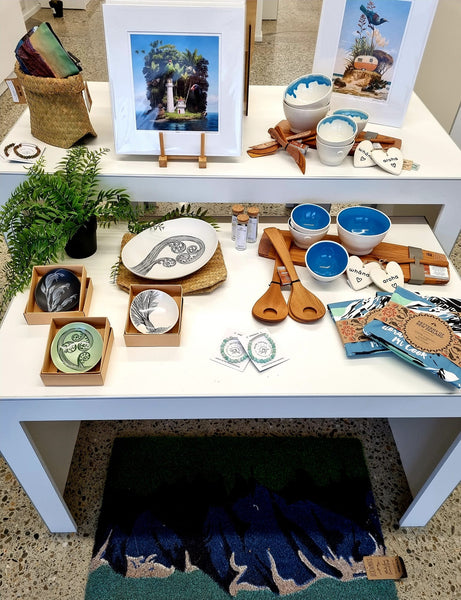 Plankwall nesting display tables x2 in retail store displaying New Zealand souvenirs