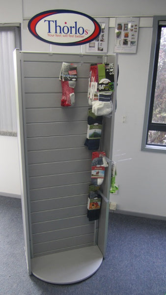 Grey Plankwall rotating Slatwall Retail display stand with one side panel displaying products in retail store