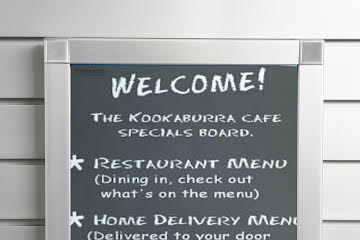 A  Plankwall aluminium snap frame with displaying a welcome sign at a cafe mounted on a slatwall.