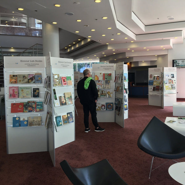 Plankwall three sided display shelves displaying books in an exhibition space
