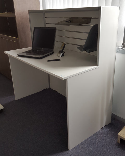 Small reception desk shown in a showroom setting