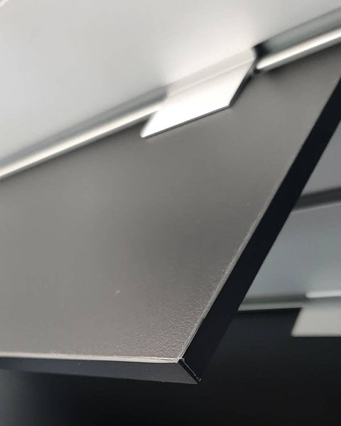 Detail view of 9mm melamine black shelf mounted on a Plankwall slatwall
