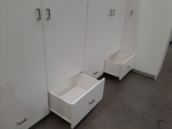 White lockers with open drawers in a room setting
