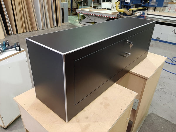 lockable short black drawer in a factory setting