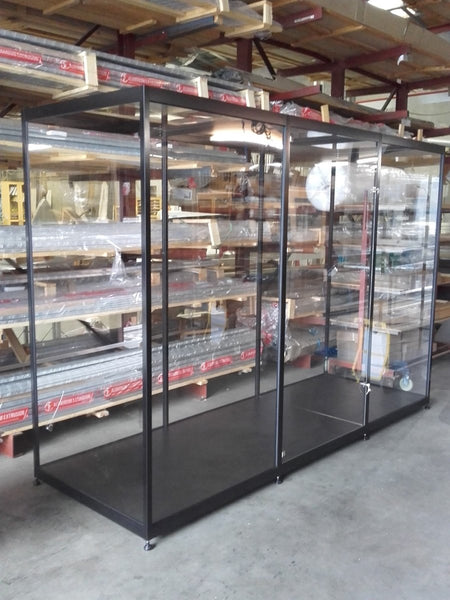 Glass-walled display case in a warehouse setting 