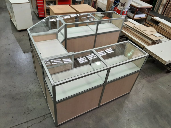 retail custom made display counter in bestwood laminate and aluminium edging and glass showcase