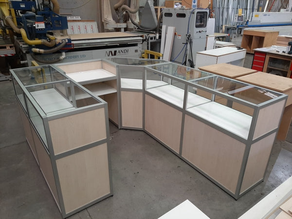 Custom Retail counter display unit with glass display cabinets in a factory setting