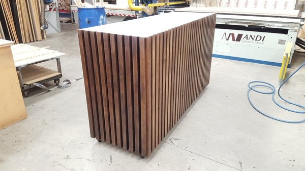 Wooden slatted counter panel on a workshop floor