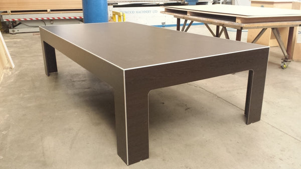 wooden low display table in factory setting