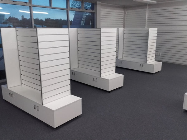bespoke design 3 custom retail gondolas in white with storage cupboards underneath