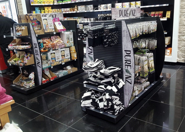 Custom black aluminium slatwall retail display units branded with NZ pure in dutyfree