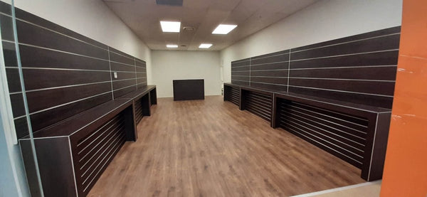 Custom wooden slatwall wall linings and display tables in a retail space