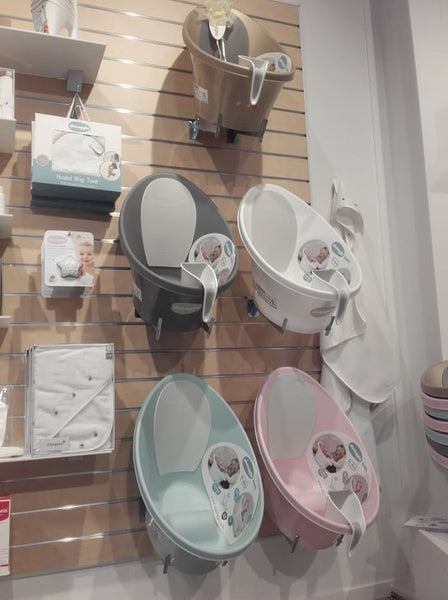 photo showing multiple displays of tilted angle metal brackets featuring baby baths